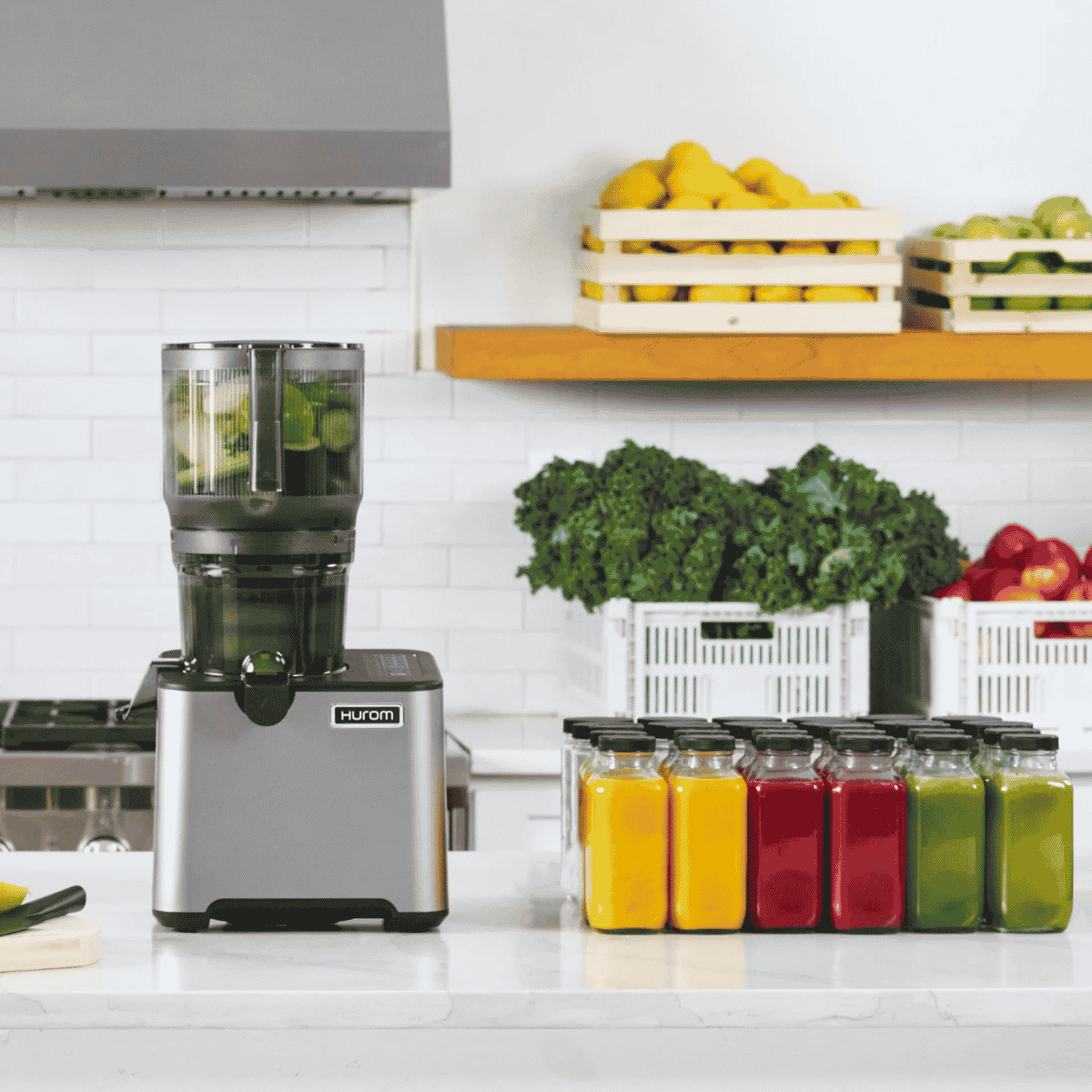 hurom CP505 slow juicer on a kitchen counter with colourful fresh juice bottles and fruits